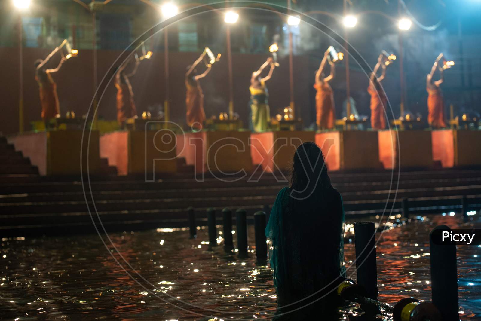 A woman watches Haarathi offering to River Godavari at Pushkar Ghat