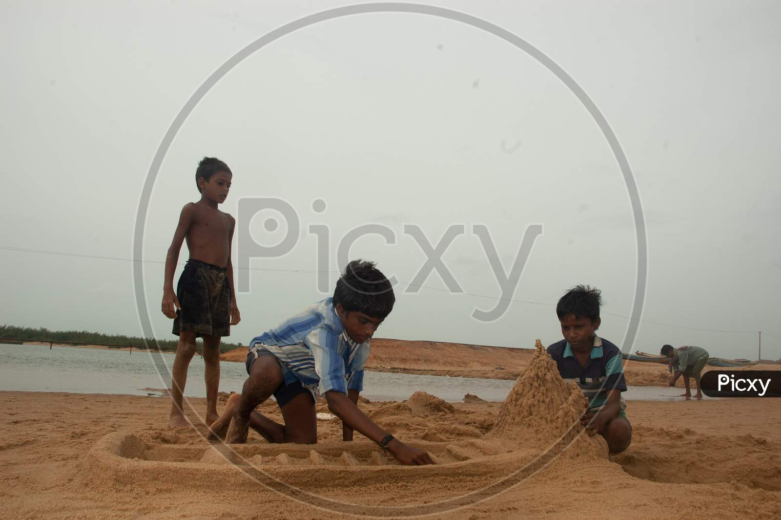 Indian Little boys building sand castles