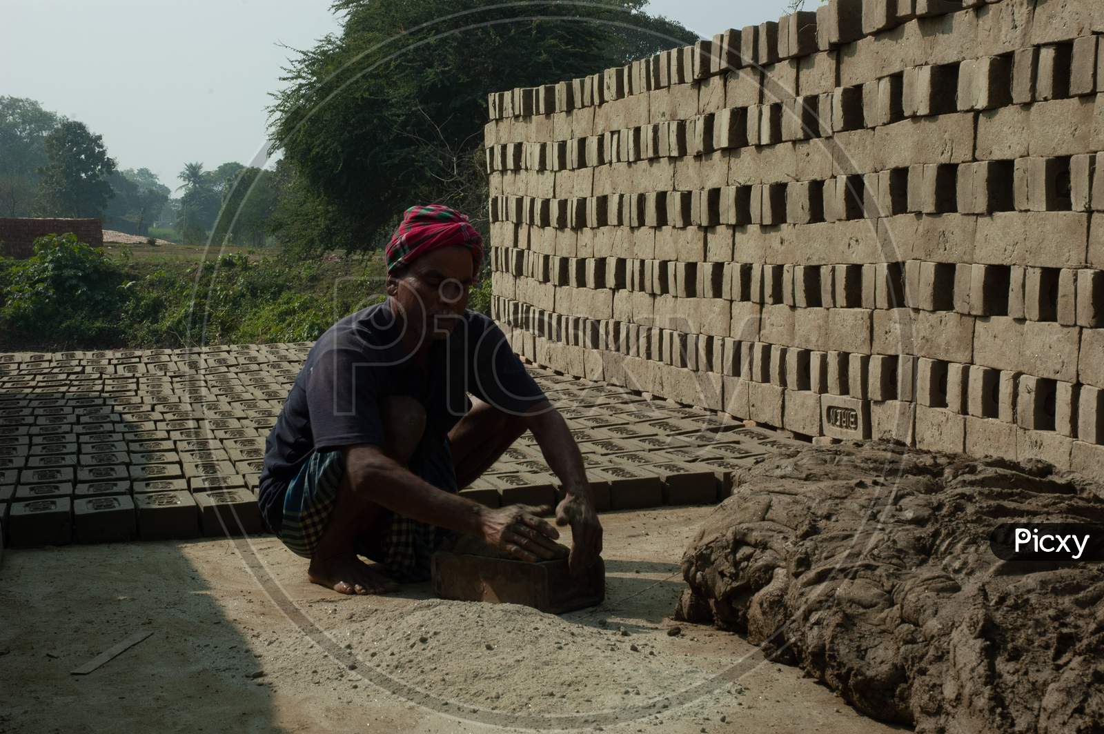 A Man Making   Clay Bricks At a Klin