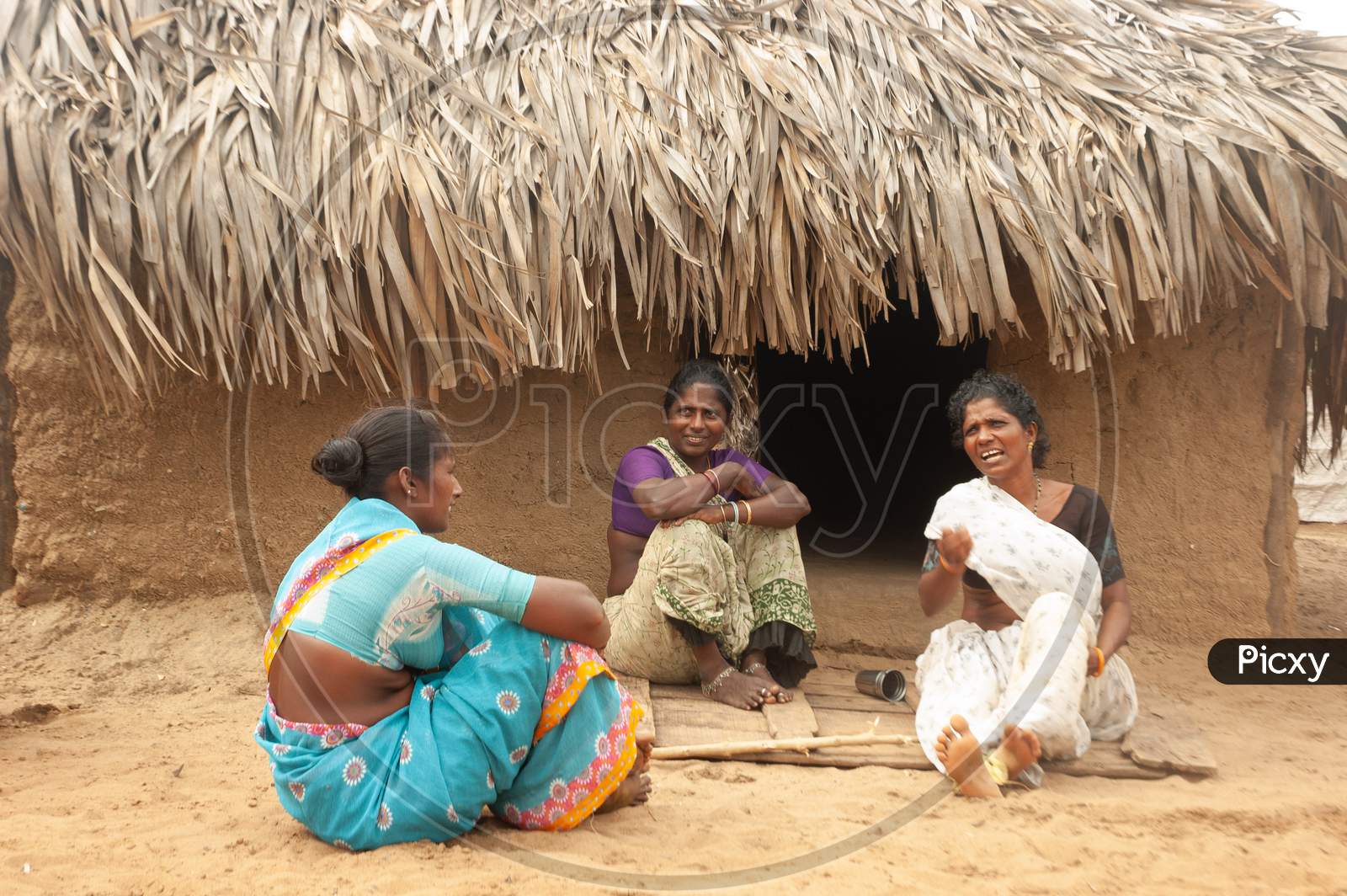 Indian Tribal Women having a conversation by the hut