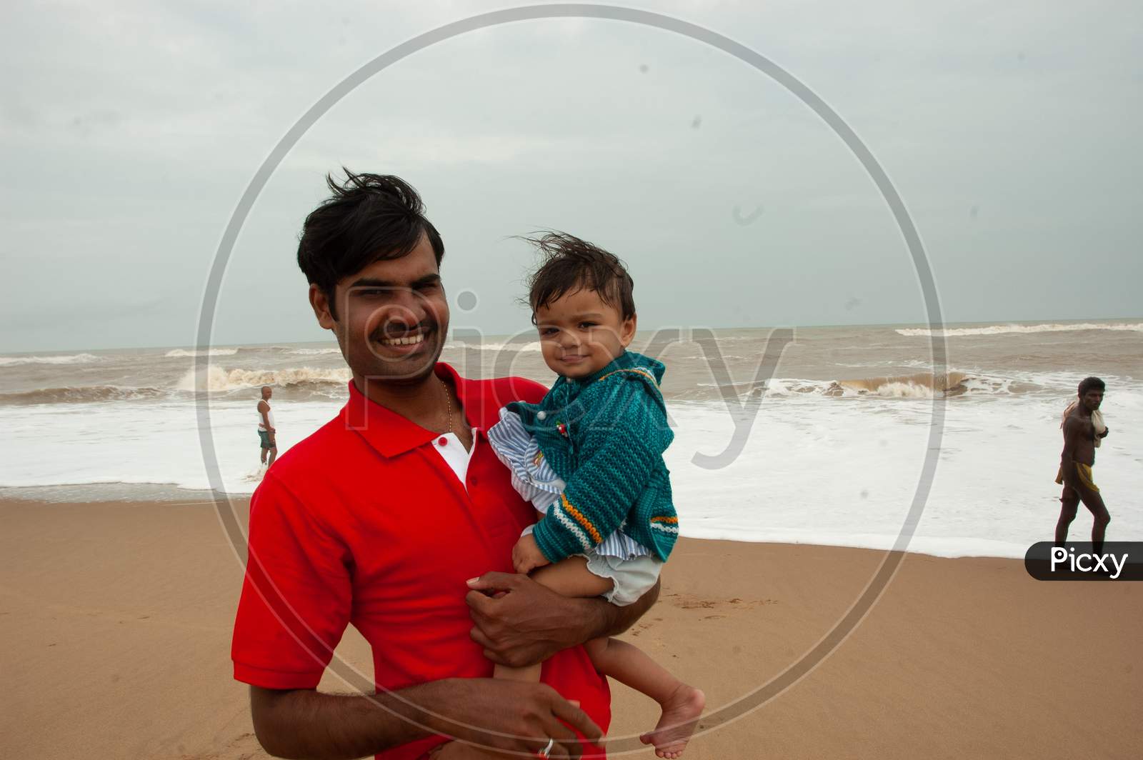 Indian Man holding a baby in his hands