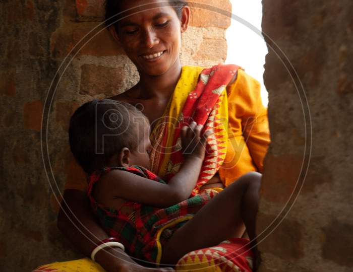 Indian Mother Feeding Baby At a Rural Village