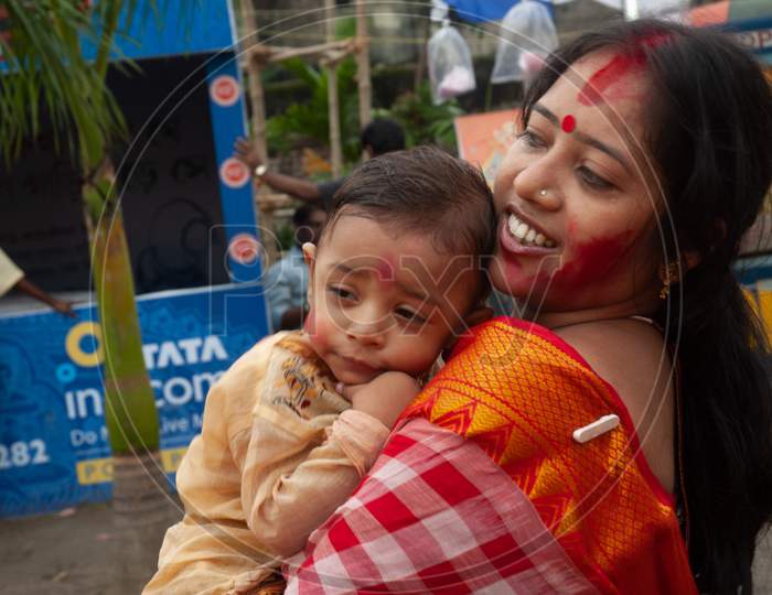 Indian Little Infant sleeping on mother's shoulder