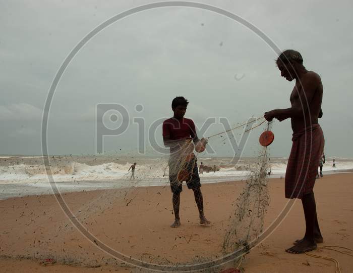 Indian fisherman adjusting the cast net