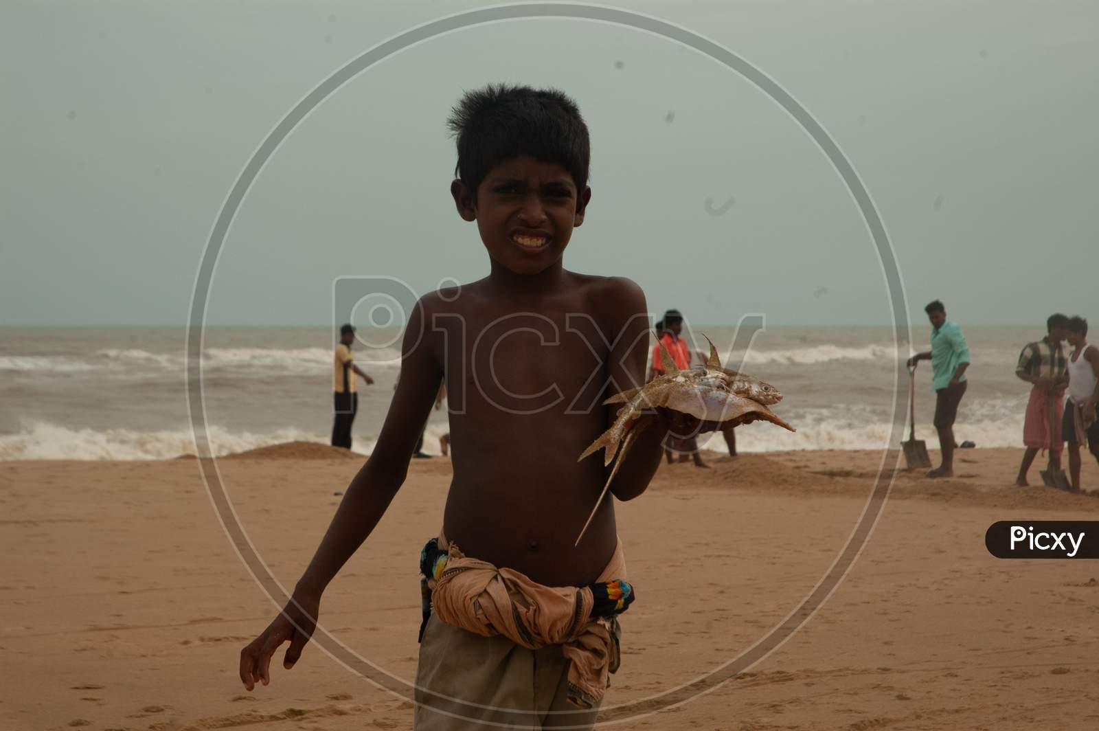 Indian Little boy showing fish