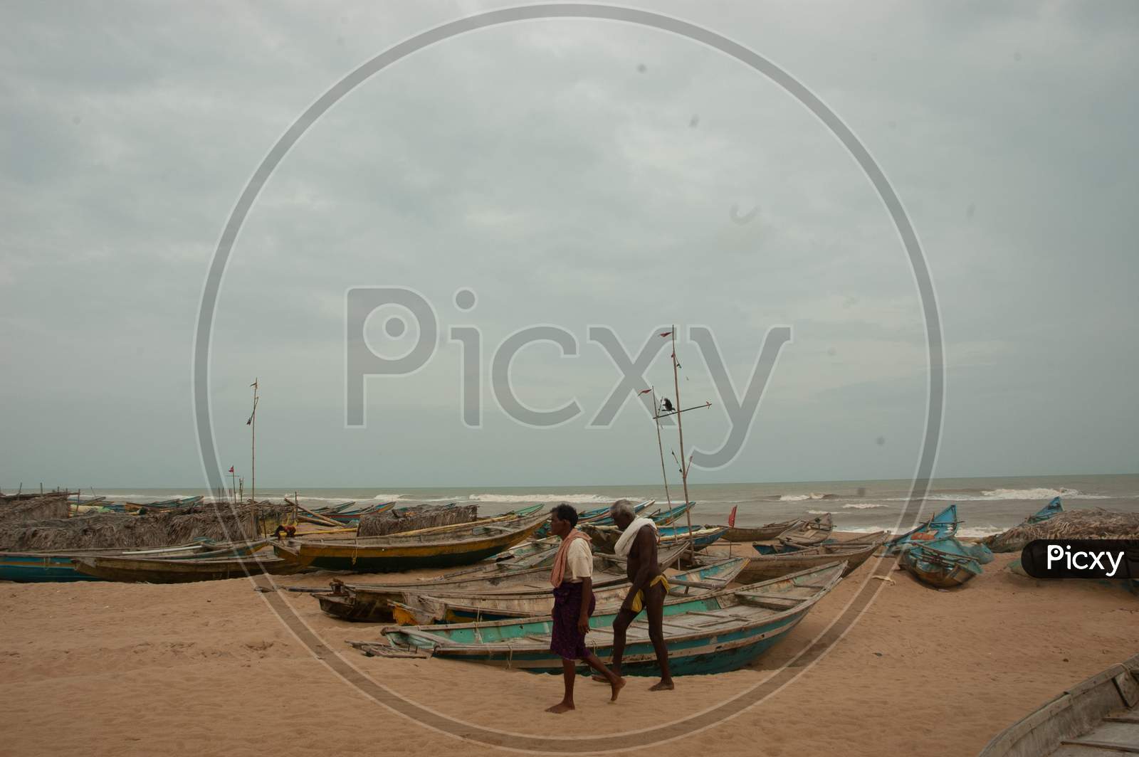 Indian Local fishermen walking by the boats