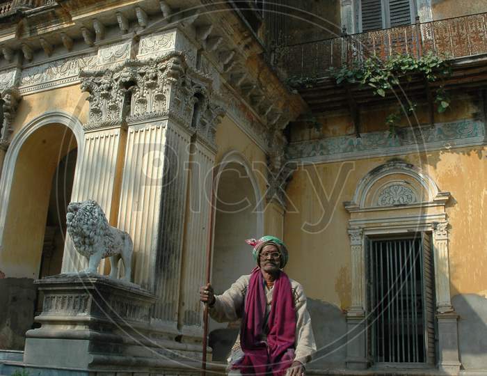 Indian Old Man sitting on a pillar