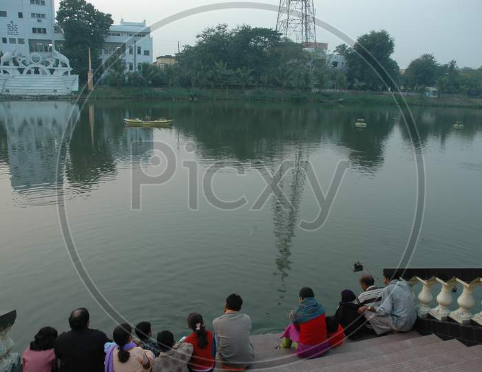 Tourists sitting on the bank of the river