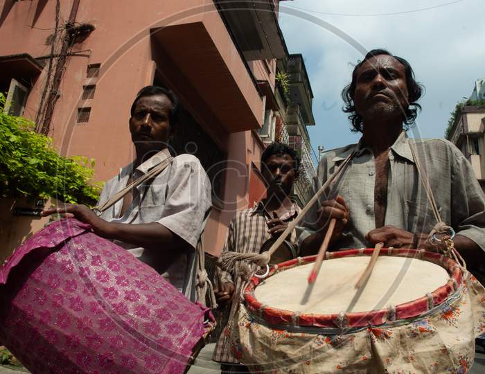 Indian Drummer playing drums during Durga Puja