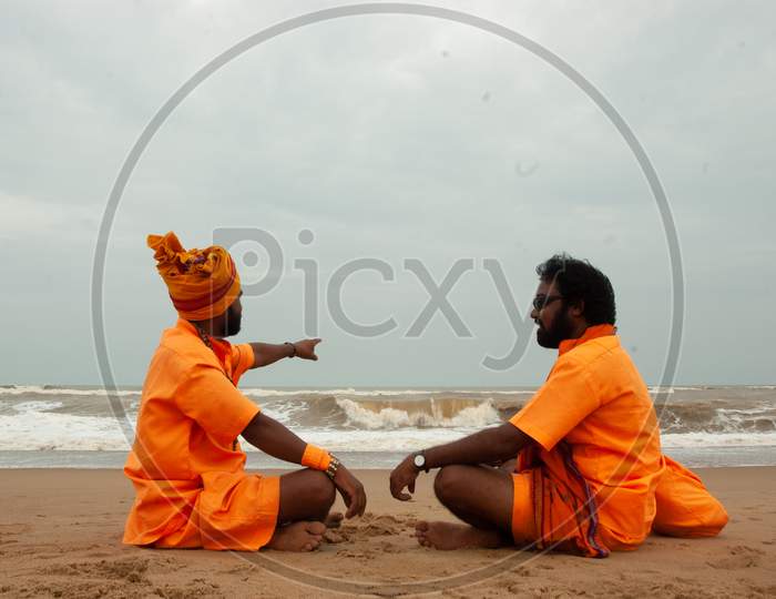 Indian Monks having a conversation by the beach
