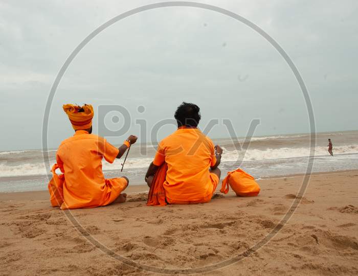 Indian Monks sitting by the beach