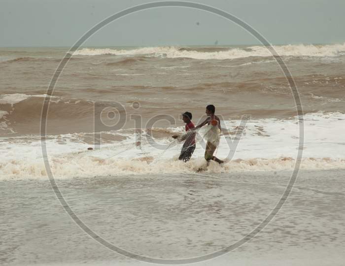 Indian boys fishing by the beach