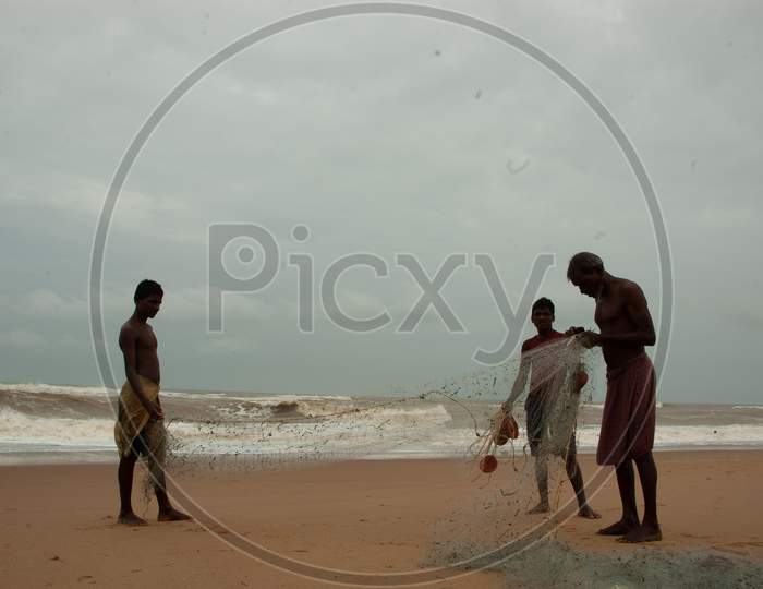Indian Men adjusting the cast net