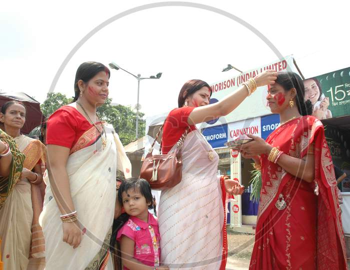 Indian women wearing bindi during Durga Pooja