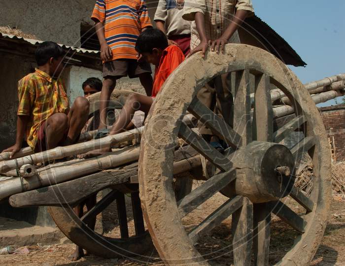 Children Playing On a Bullock Cart At A Rural Village Streets  in Murshidabad, West Bengal