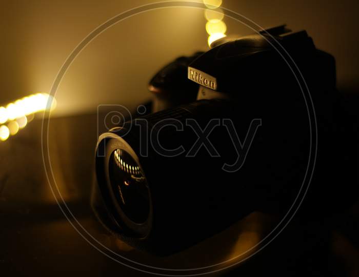 Nikon DSLR Camera With Bokeh Lights Background