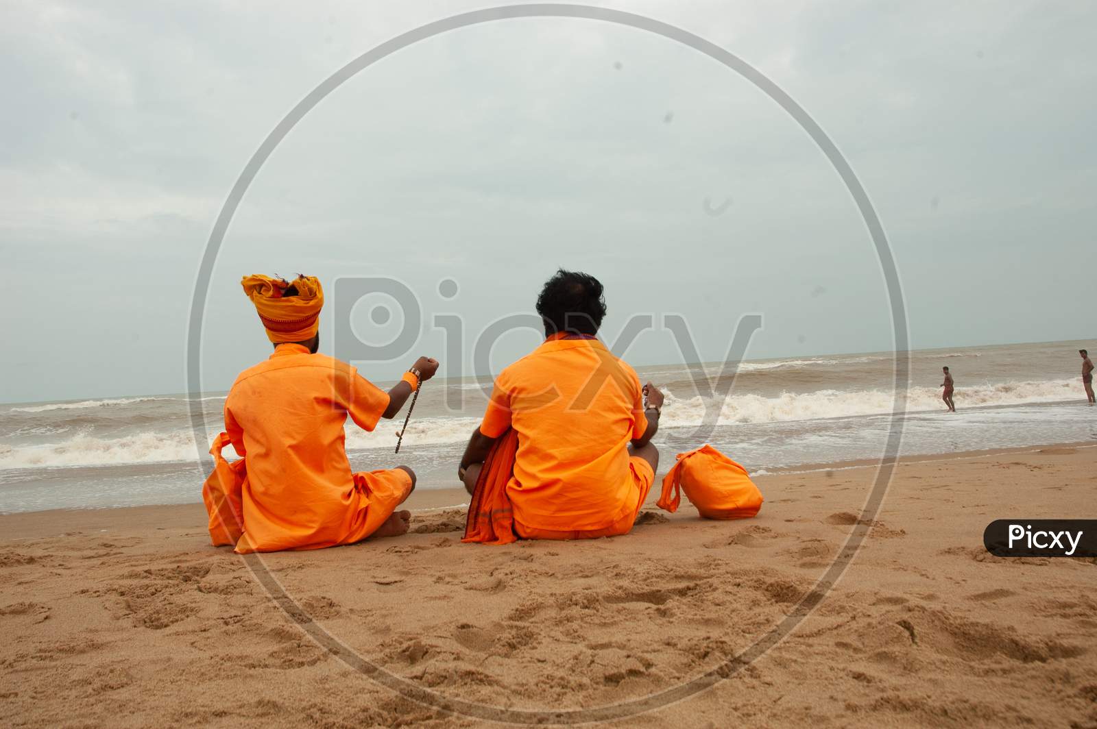 Indian Monks sitting by the beach