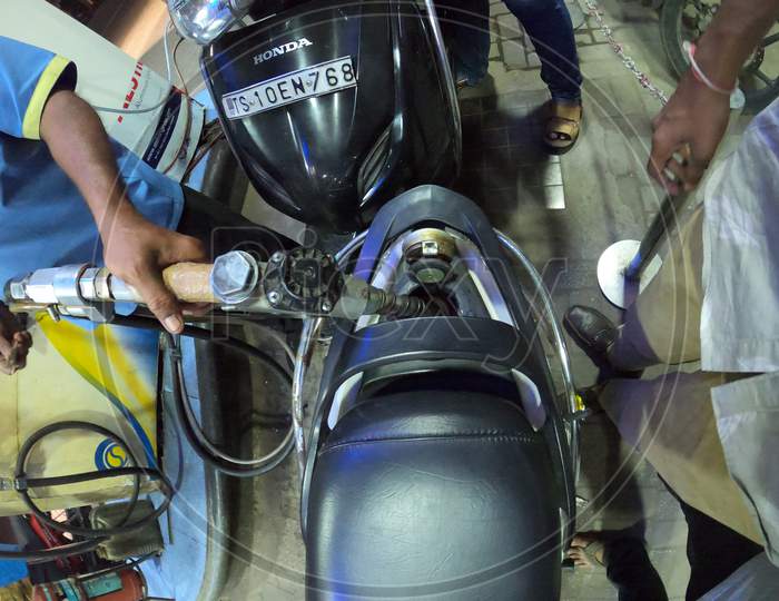 Fuel Filling In an Scooty  At an Fuel Station
