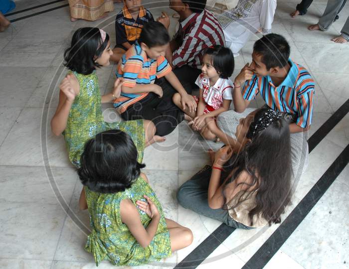 Indian Children playing sitting on the floor