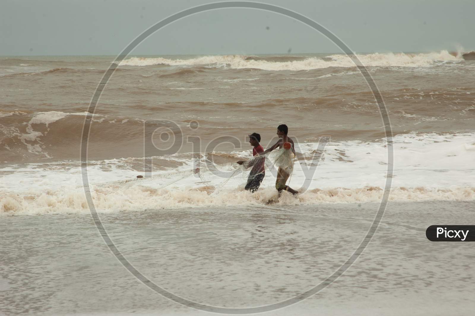 Indian boys fishing by the beach