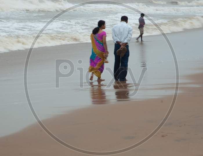 Indian Middle aged couple walking by the beach