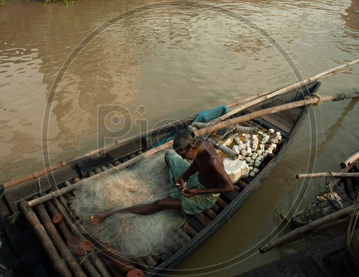 Indian Old Fisherman making the cast net
