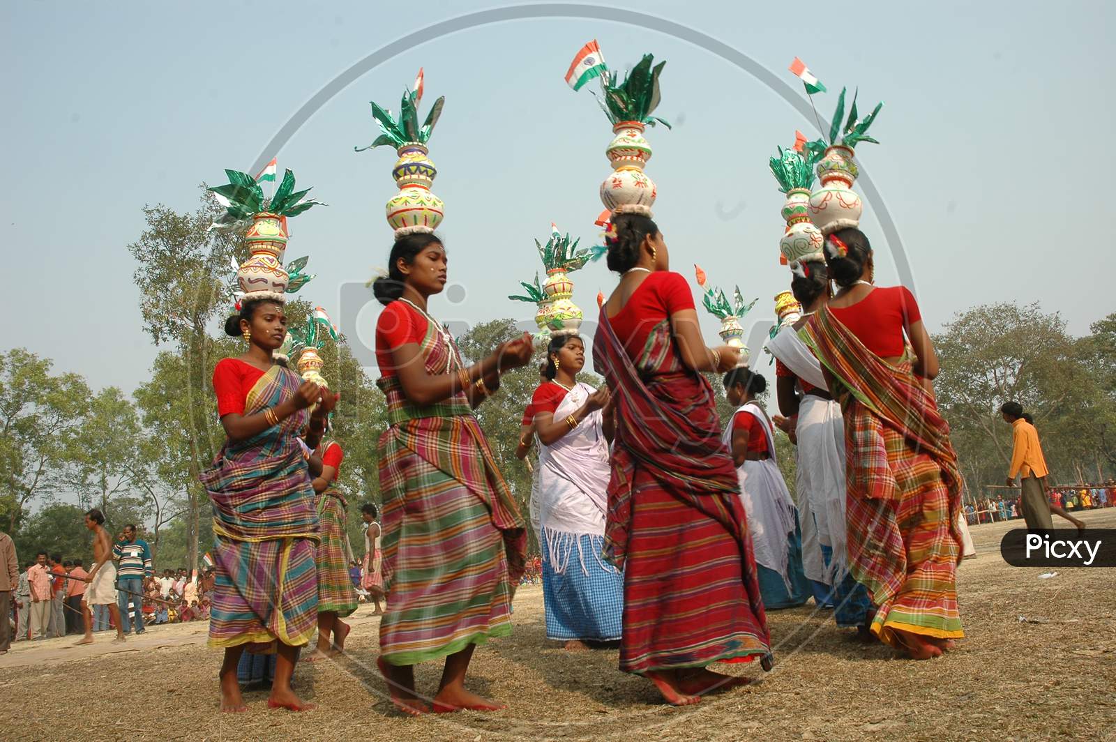 Indian Tribal People Performing Traditional Folk Dance  With Pots On Their Heads During Festivals in Murshidabad, West Bengal