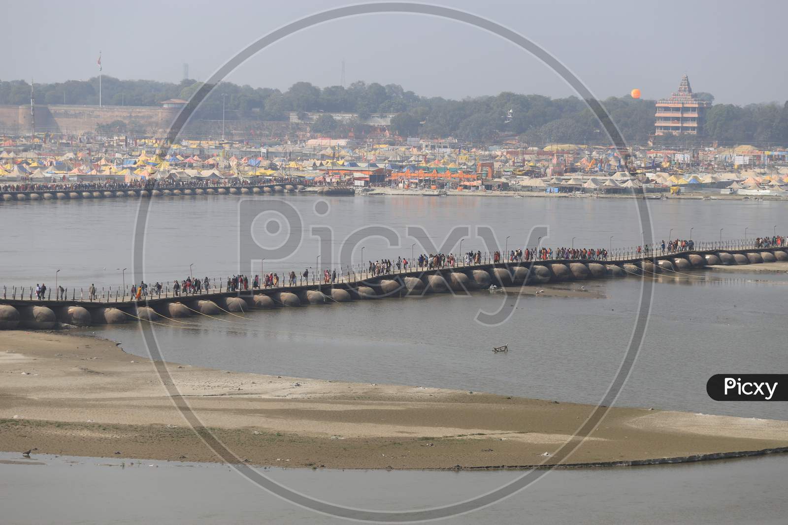 Hindu Devotees And Sadhu Crossing Bridge In Prayagraj During Magh Mela