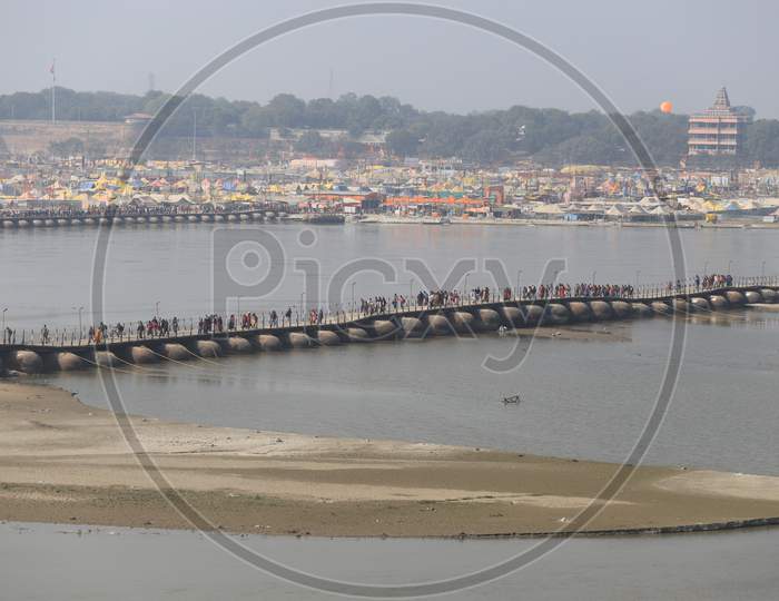 Hindu Devotees And Sadhu Crossing Bridge In Prayagraj During Magh Mela