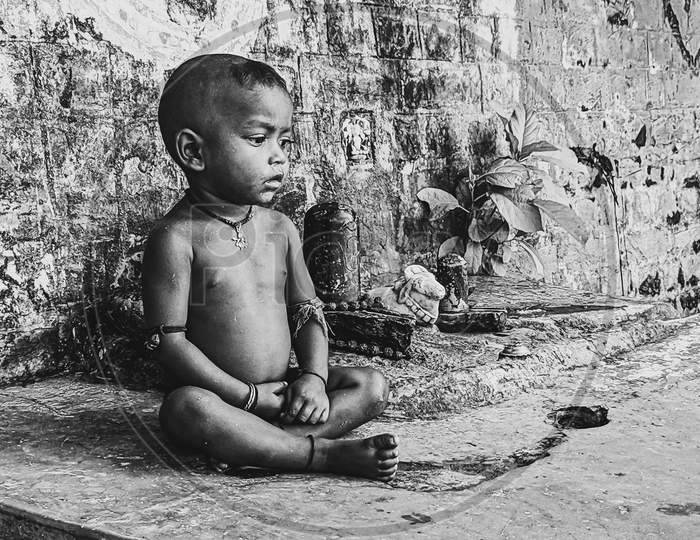 Indian Young Boy Sitting on  Rural Village House