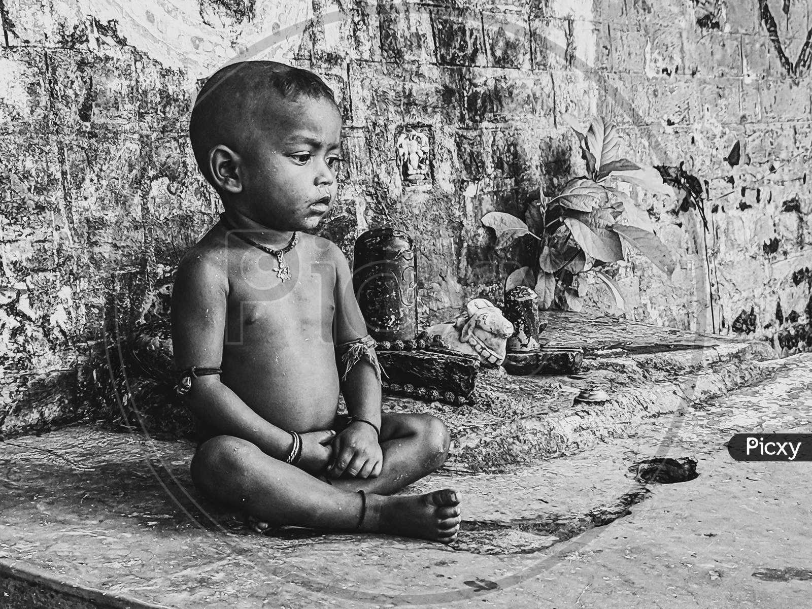 Indian Young Boy Sitting on  Rural Village House