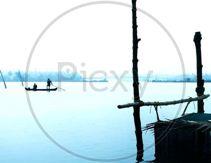 Silhouette Of Fisherman In an Lake