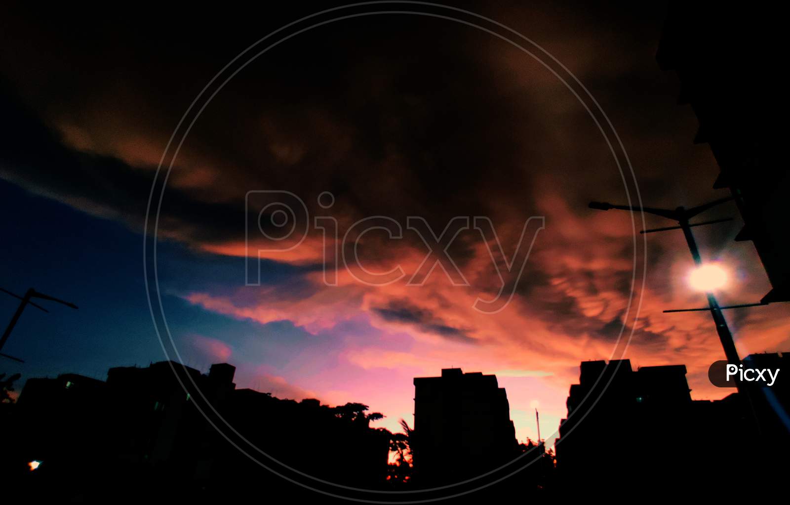Silhouette  Of Buildings Over Sunset Sky