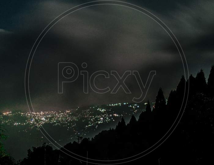 City Scape View With Night City Lights From a Hill