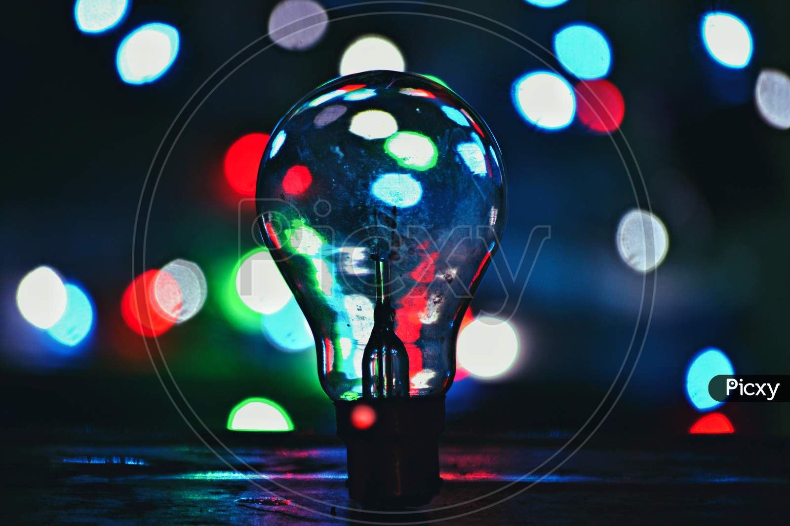 Electric Filament Bulb Over Led Bokeh Background