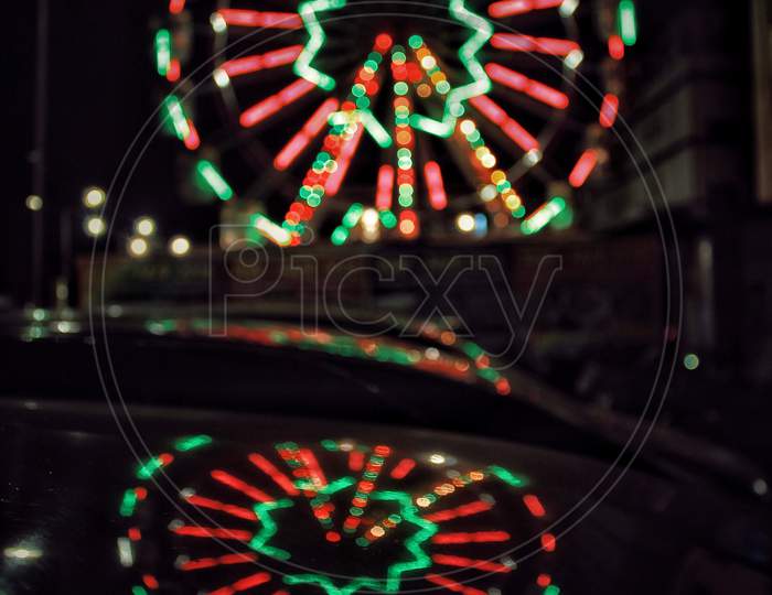 Long Exposure Of an Giant Wheel With Neon Lights   In a Fair