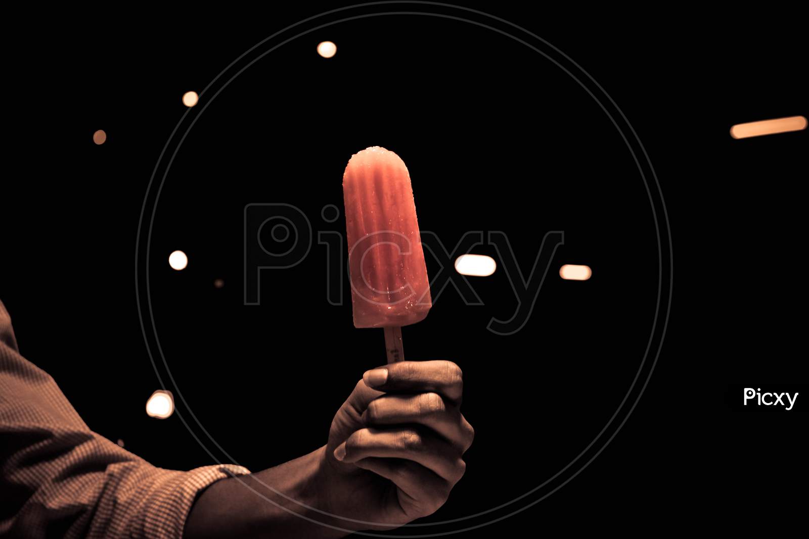 Man Hand Holding an Ice Cream Stick