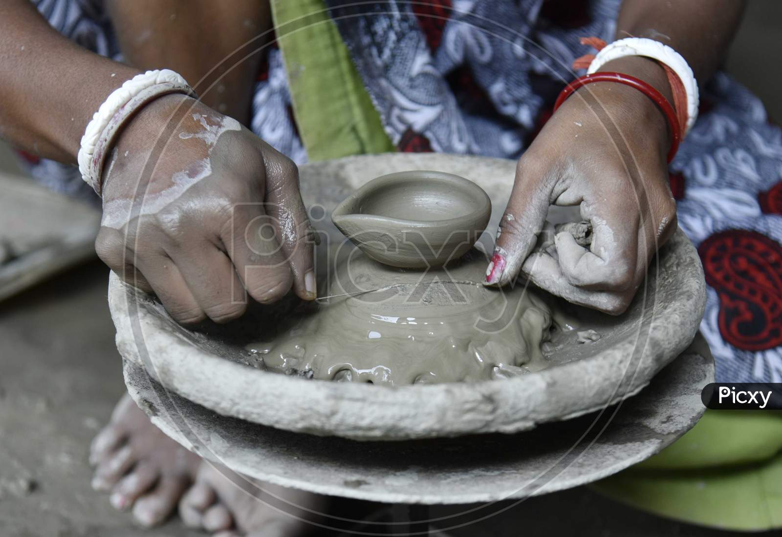 Woman Potter Prepares A Clay Lamps In Her Residence Ahead Of Diwali Festival, In The Outskirt Of Guwahati, In Assam