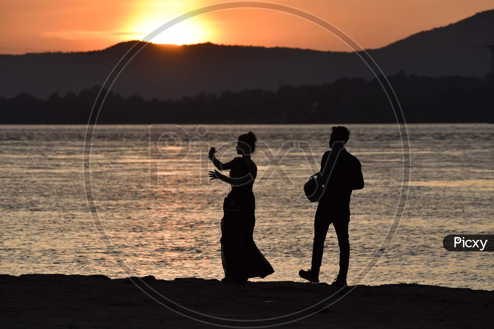 A Couple Takes Selfie During Sunset In The Banks Of The Brahmaputra River, In Guwahati, Assam, India