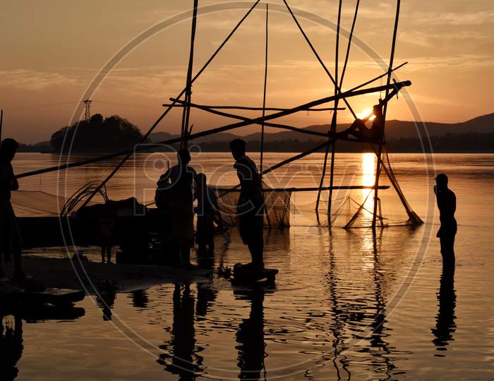 Silhouette of Fisherman With China Fishing Nets On Bramhaputra River Bank in Guwahati