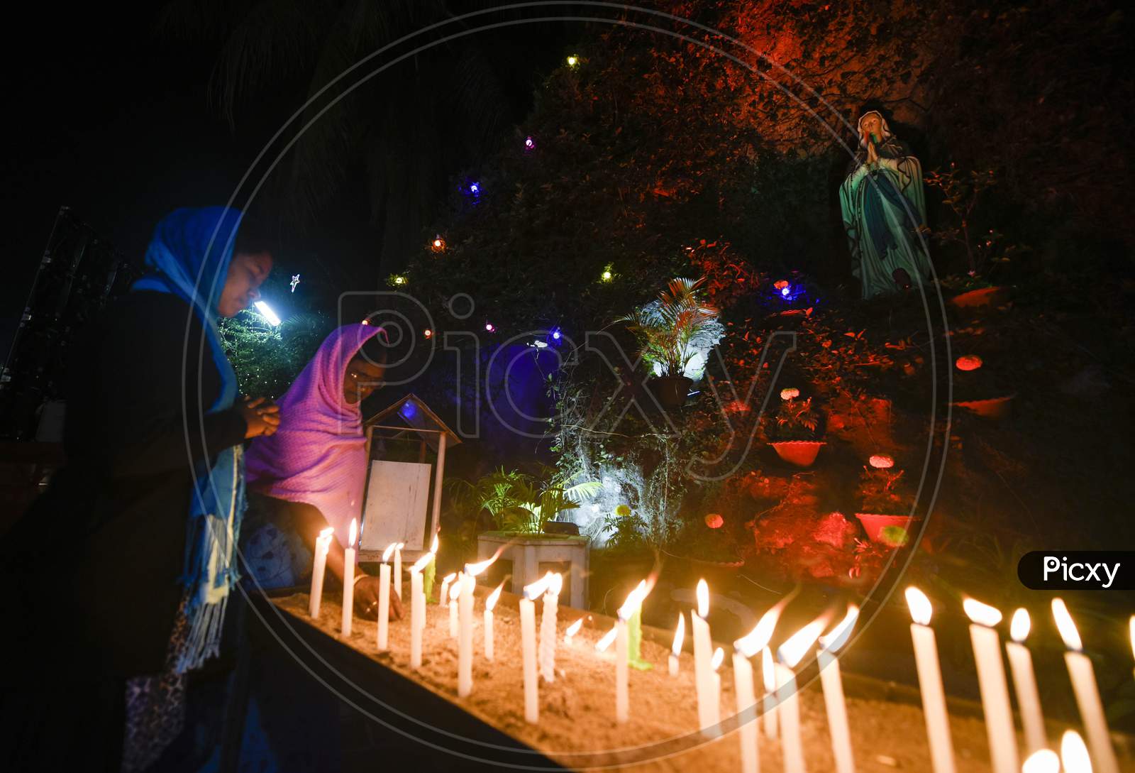 Devotees Light Candles At Saints Johns Church, On The Eve Of Christmas In Guwahati