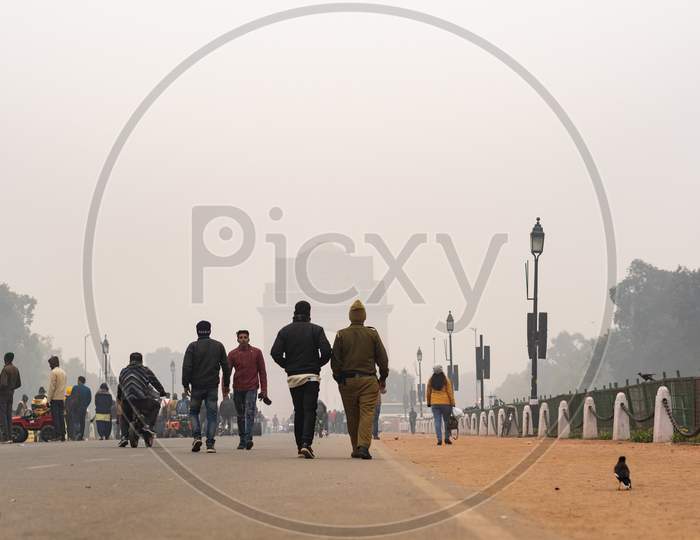 People walking in the foggy evening during winters in Delhi NCR