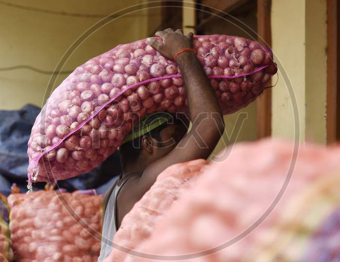Daily Worker Carrying Onions in an Market