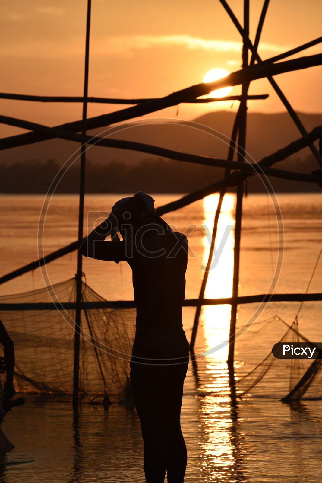 Silhouette Of Fisherman With China Fishing Nets At Bramhaputra River Bank  in Guwahati