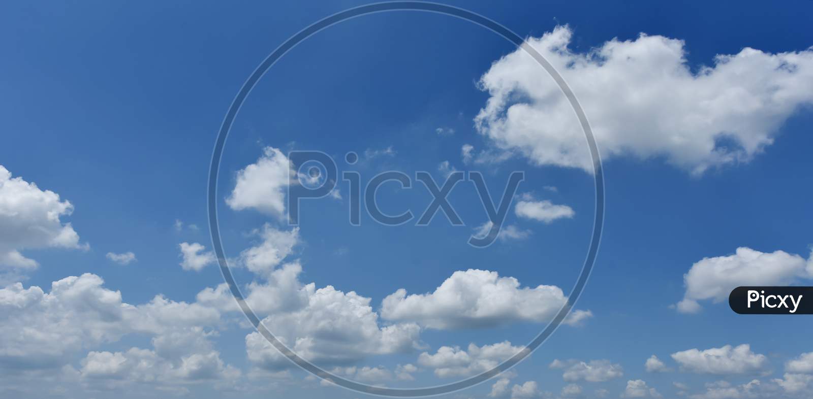 Blue Sky With Cotton Clouds  Forming a Background