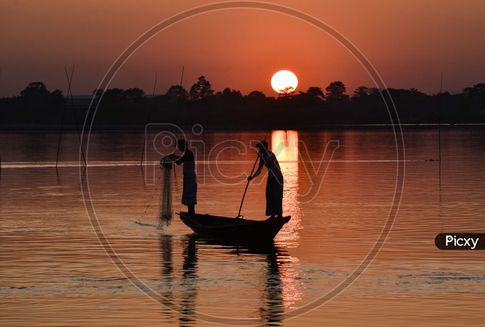 Indian Fishermen Fishing In Beki River During Sunset, At Sarbhog In Barpeta District Of Assam