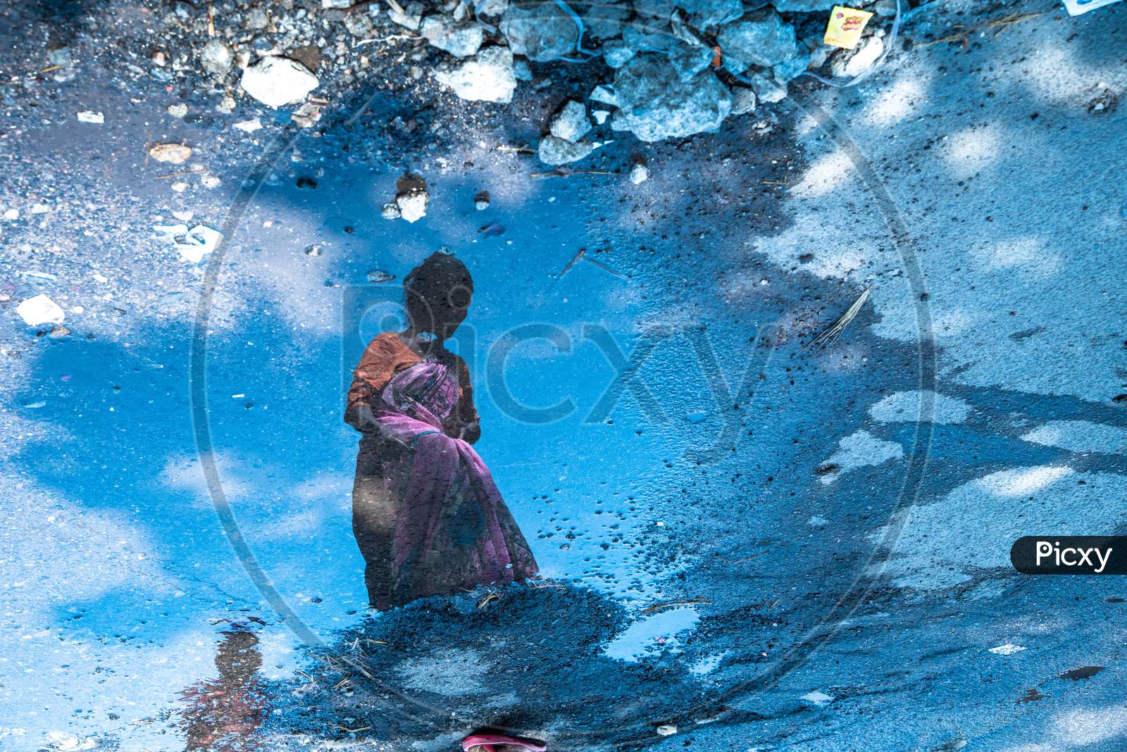 Reflection Of an Old Woman On Water Surface