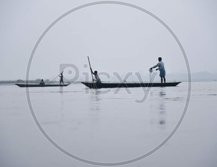 Fishermen Lay Their Fishing Net In The Manas River In Baksa District Of Assam