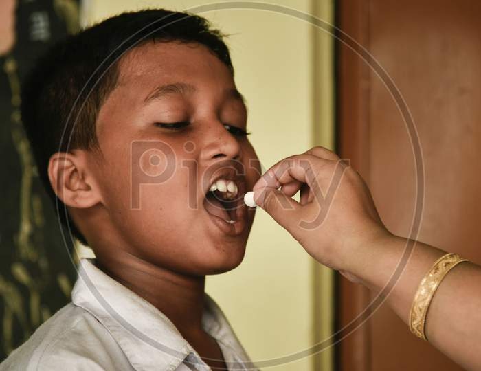 School Student Recieves Albendazole Tablet As Part Of India'S National Deworming Programme At A Primary School In Guwahati, Assam, India