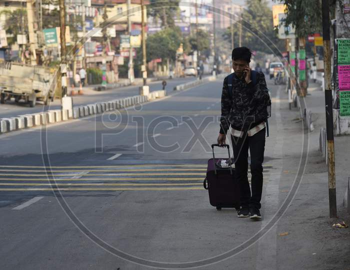 People Walking With Luggage In The Street, During A Strike Called By All Assam Students’ Union (Aasu) And The North East Students’ Organisation (Neso) In Protest Against The Citizenship Amendment Bill, In Guwahati